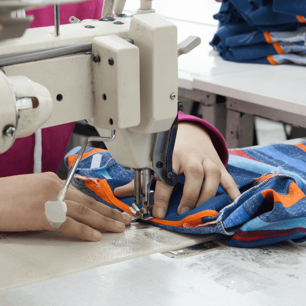 any pest control near me - Pests and What It Could Do to Your Clothing WholesaleRetail Business - a pair of hands sewing clothes using a machine